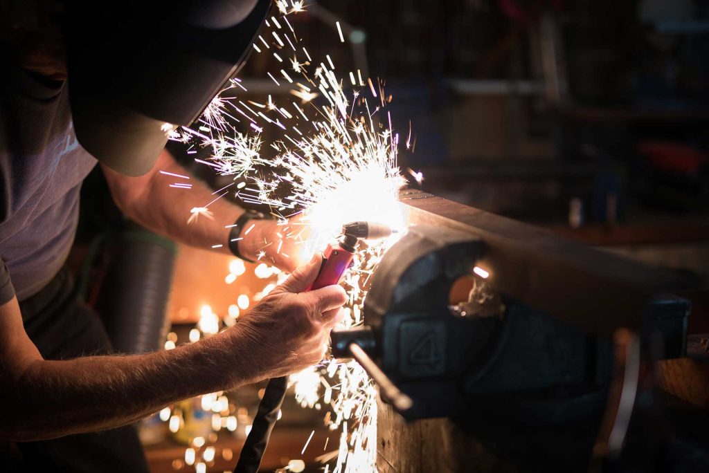 A welder at work, sparks flying as metal is joined together